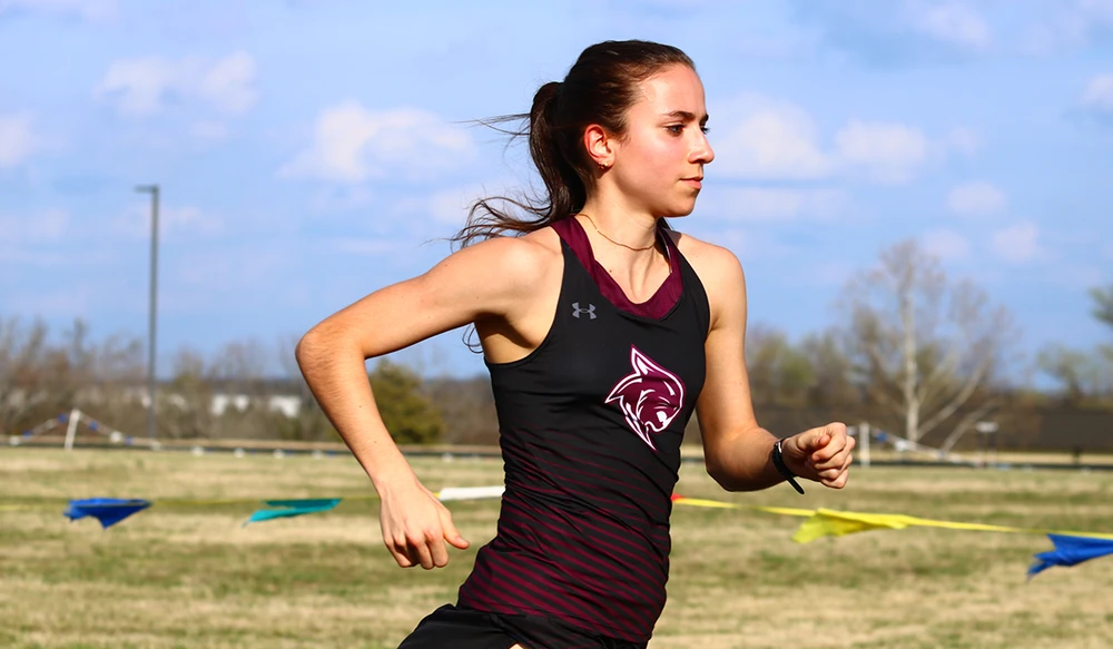 Student running on the College of the Ozarks Track